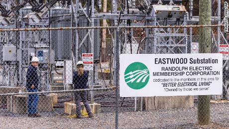 Workers with Randolph Electric Membership Corporation work to repair the Eastwood Substation in West End, North Carolina, on December 6, 2022. 