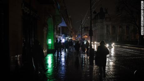 Amid the blackouts, lighting on the streets is minimal, with the majority coming from public transport and car headlights in the western city of Lviv on November 16, 2022.