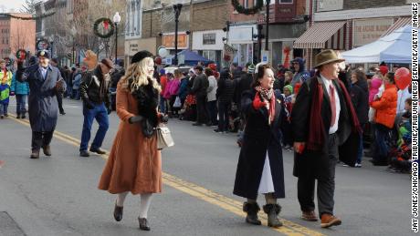 Locals who are dressed as characters from &quot;It&#39;s a Wonderful Life&quot; greet the crowd as they walk through downtown Seneca Falls during the 2017 festival parade.