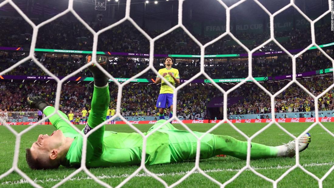 Croatian goalkeeper Dominik Livaković celebrates after Marquinhos hit the post on the last kick of the penalty shootout. It was Croatia&#39;s second straight shootout win in this World Cup.