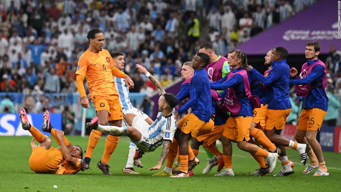Van Dijk knocks over Paredes as Dutch players run onto the field in the second half. The skirmish started after a hard Paredes foul on Nathan Aké. Paredes then smashed the ball into the Dutch bench.