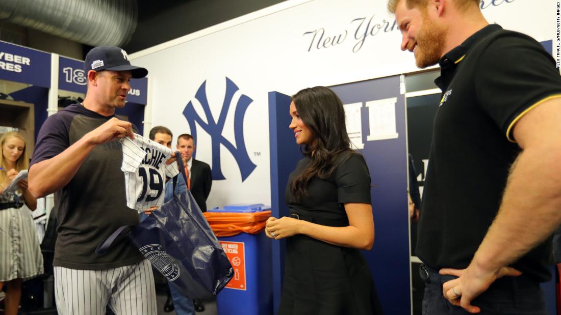 New York Yankees manager Aaron Boone presents the couple with a jersey for Archie before a Major League Baseball game in London in June 2019.