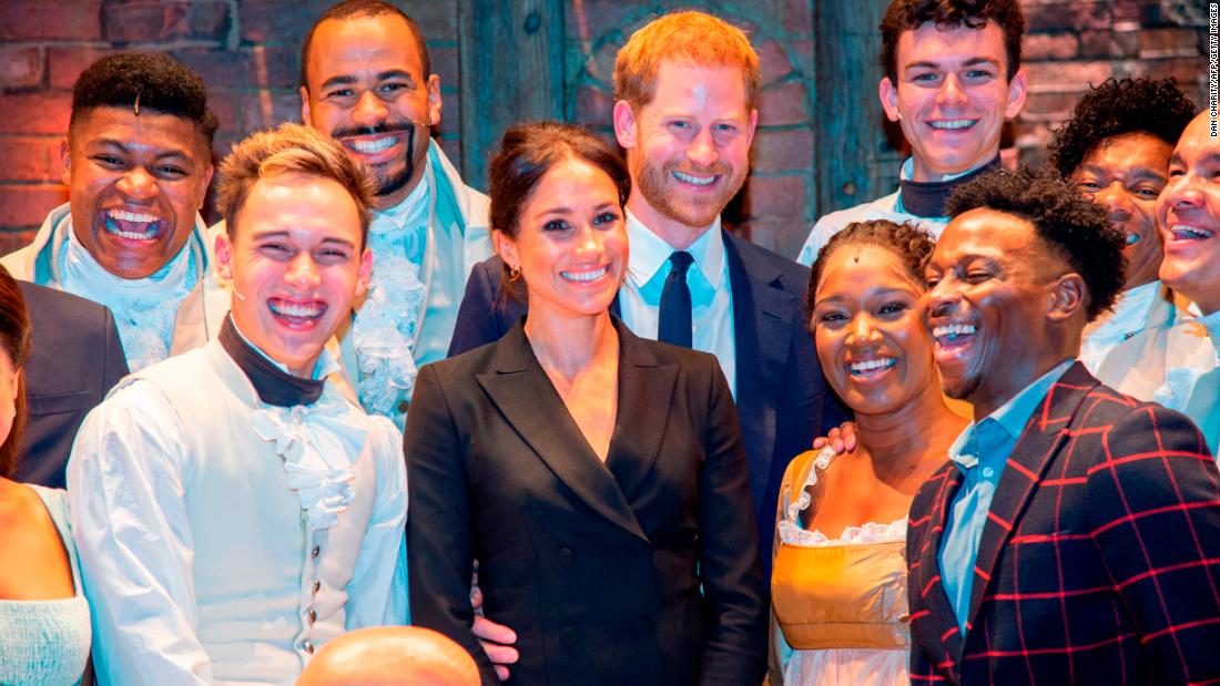 Meghan and Harry pose with the cast and crew of the musical &quot;Hamilton&quot; after a performance in London in August 2018. Harry gave those in the theater something to remember after &lt;a href=&quot;https://www.cnn.com/2018/08/30/uk/prince-harry-meghan-markle-hamilton-intl/index.html&quot; target=&quot;_blank&quot;&gt;breaking into mock-song&lt;/a&gt; at the end of the show. The show was held to raise money for his HIV charity, Sentebale.