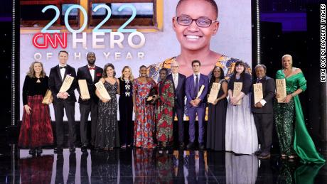 NEW YORK, NEW YORK - DECEMBER 11: (L-R) Carie Broecker, Richard Casper, Tyrique Glasgow, Nora El-Khouri Spencer, Kelly Ripa, CNN Hero of the Year Nelly Cheboi, Christina Cheboi Chebii, Anderson Cooper, Aidan Reilly, Meymuna Hussein-Cattan, Teresa Gray, Bobby Wilson, and Debra Vines pose onstage during the 16th annual CNN Heroes: An All-Star Tribute at the American Museum of Natural History on December 11, 2022 in New York City. (Photo by Mike Coppola/Getty Images for CNN)