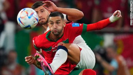 Morocco&#39;s Hakim Ziyech fights for the ball with Portugal&#39;s Ruben Dias during the quarterfinal that The Atlas Lions won 1-0.