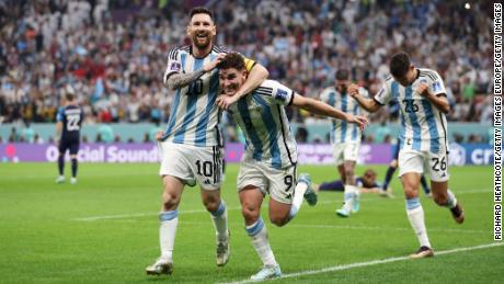 Julian Alvarez celebrates with Lionel Messi after doubling Argentina&#39;s lead.