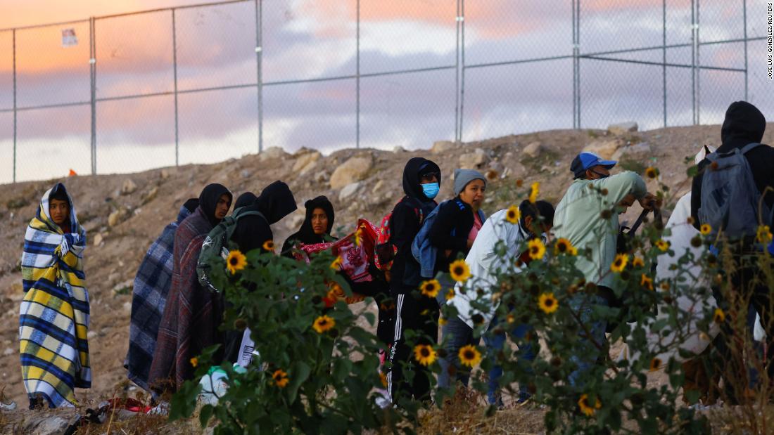 Migrants walk near the border wall between Ciudad Juarez and El Paso on December 13.