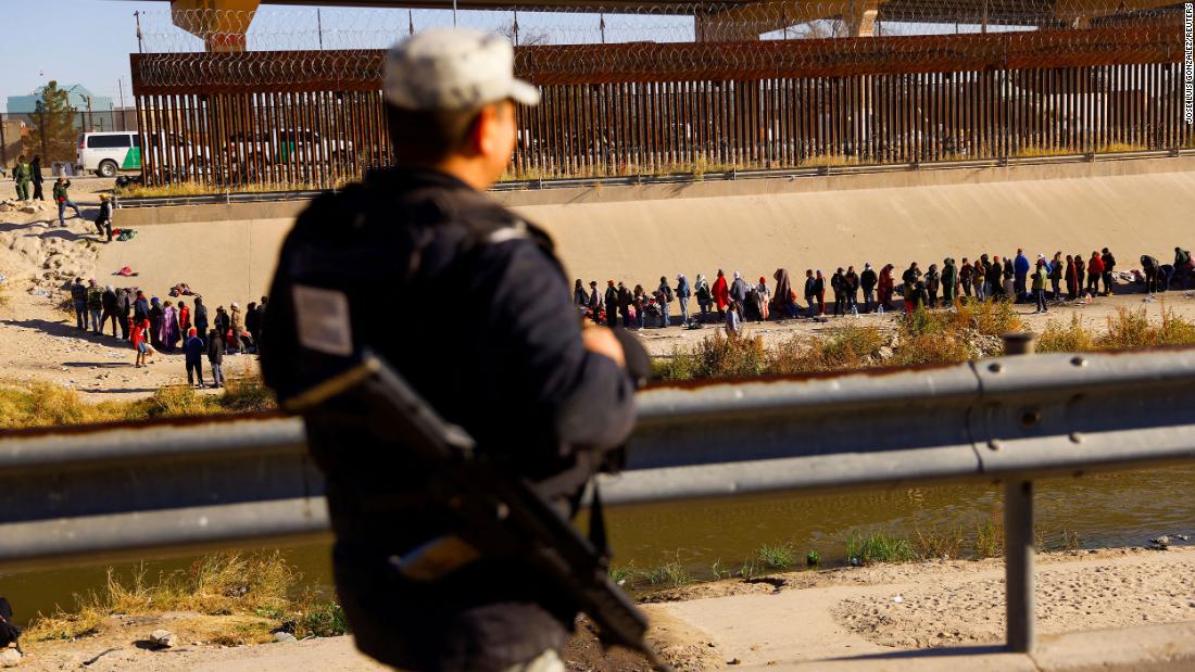 A member of the Mexican army watches migrants on December 12.