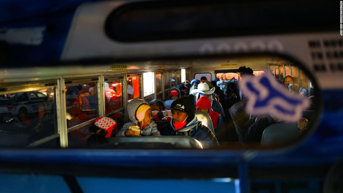 Migrants ride a bus on their way to the United States to request asylum on December 11.
