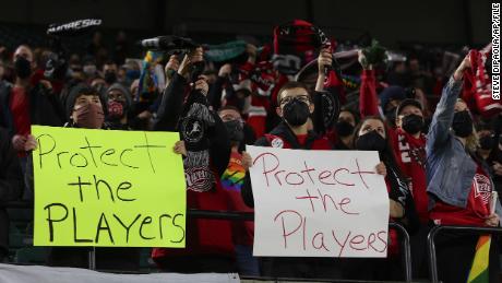 Portland Thorns fans hold signs during the first half of the team&#39;s National Women&#39;s Soccer League soccer match against the Houston Dash in Portland, Oregon, on October 6, 2021.