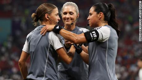 Referees Stephanie Frappart, Neuza Ines Back, and Karen Diaz Medina shake hands as they warm up prior to the Group E match between Costa Rica and Germany.