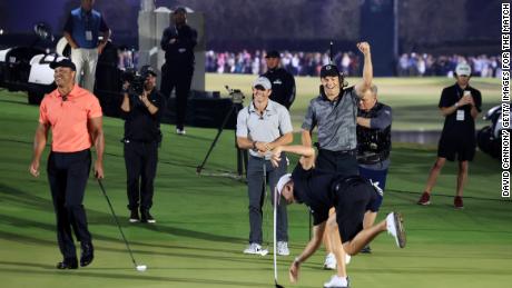 Jordan Spieth and Justin Thomas celebrate as Tiger Woods and Rory McIlroy look on during The Match at Pelican Golf Club on December 10.