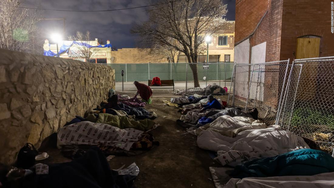 Migrants sleep in the cold outside a bus station in El Paso on December 18.