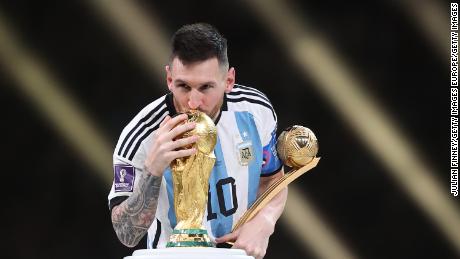 Lionel Messi kisses the World Cup trophy during the presentation ceremony. 