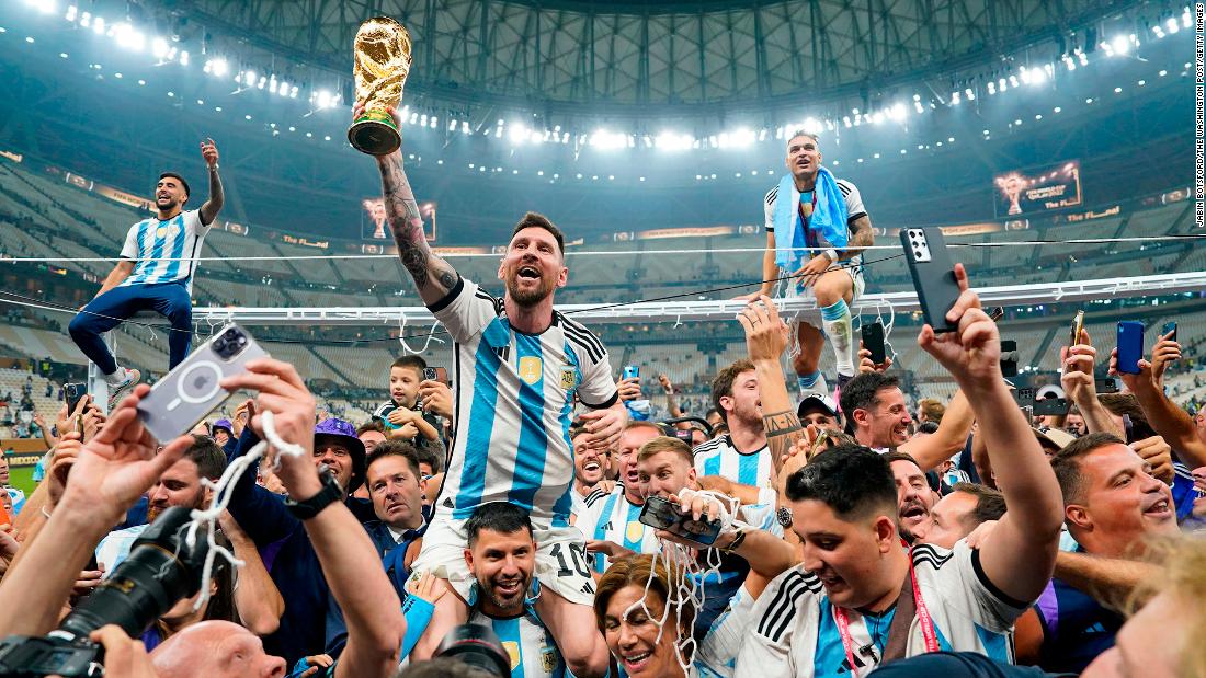 Lionel Messi holds up the World Cup trophy after Argentina defeated France in the tournament final on Sunday, December 18.