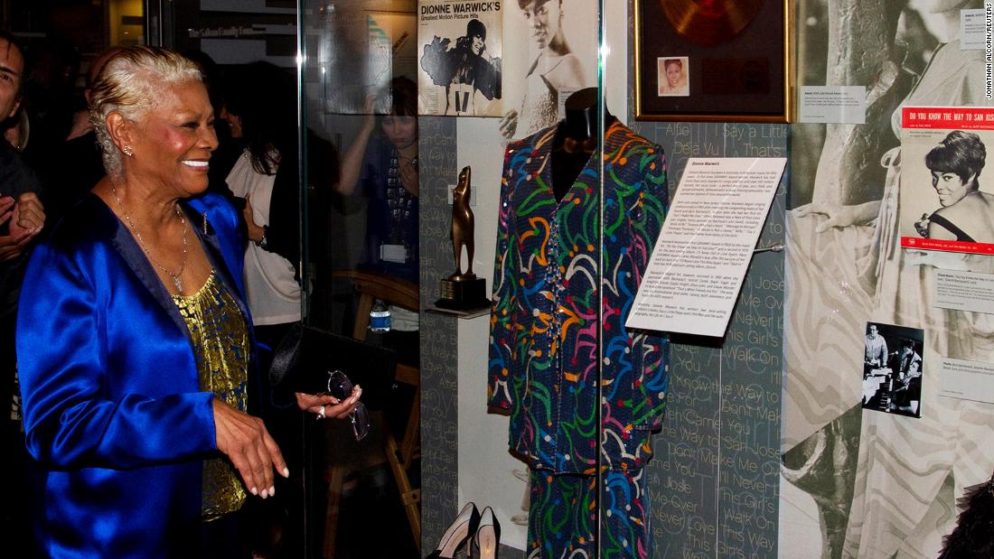 Warwick observes an exhibit about her life at the Grammy Museum before attending an event that celebrated the 50th anniversary of her career in 2012.