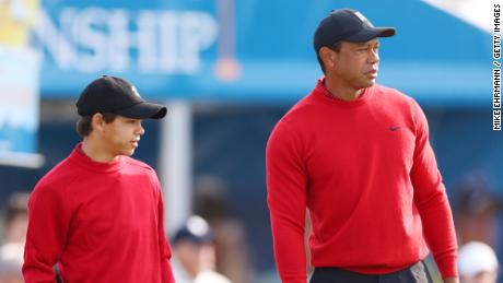 Seeing double: Tiger Woods and son Charlie tee off in perfect symmetry wearing famous Sunday red