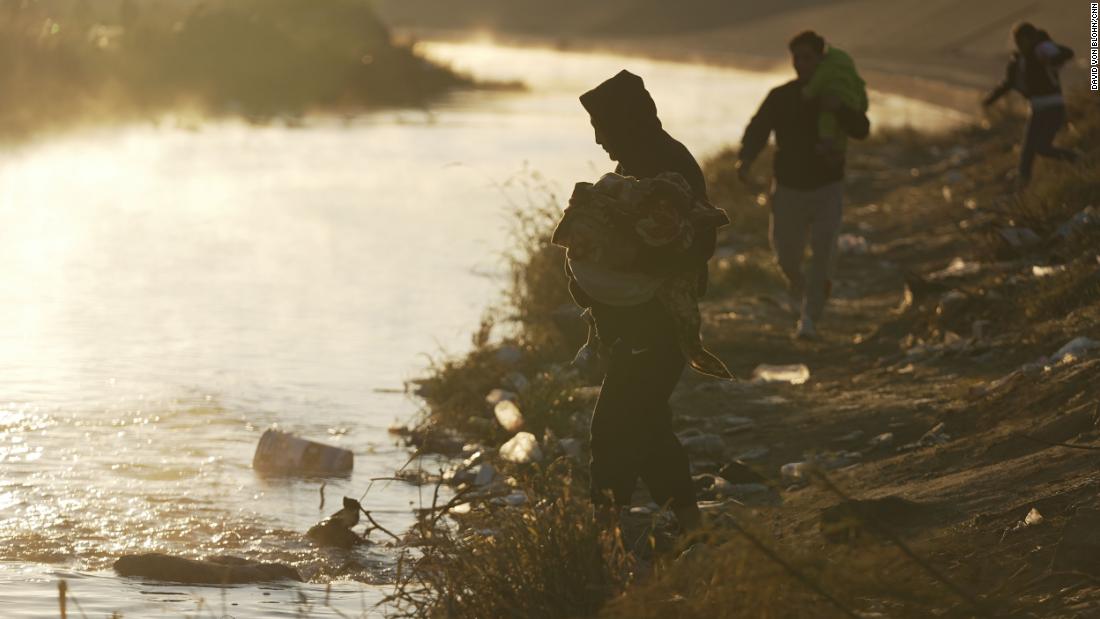 A group of migrants cross the Rio Grande into the United States on December 19.