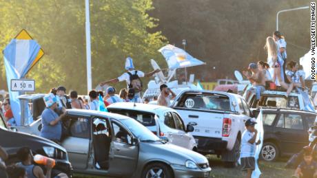 Argentina fans wave flags outside the national men&#39;s team training ground ahead of their arrival in Buenos Aires.