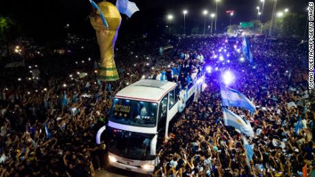 Argentina&#39;s players celebrate on board a bus with supporters after winning the World Cup.