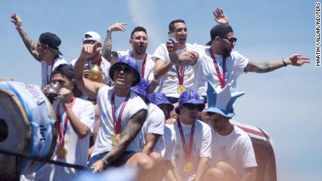 Argentina players celebrate on the bus with the World Cup trophy during Tuesday&#39;s parade. 