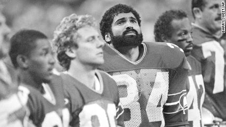 Running back Franco Harris (34) stands with Seattle Seahawks teammates before the game against San Diego, Sept. 11, 1984, in Seattle. Harris joined the Seattle Seahawks after Curt Warner suffered a knee injury in the Seahawks season opener. Seattle won 31-17.