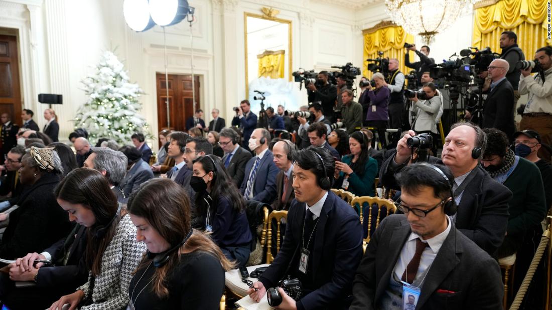 Members of the media listen during the news conference in the East Room of the White House.