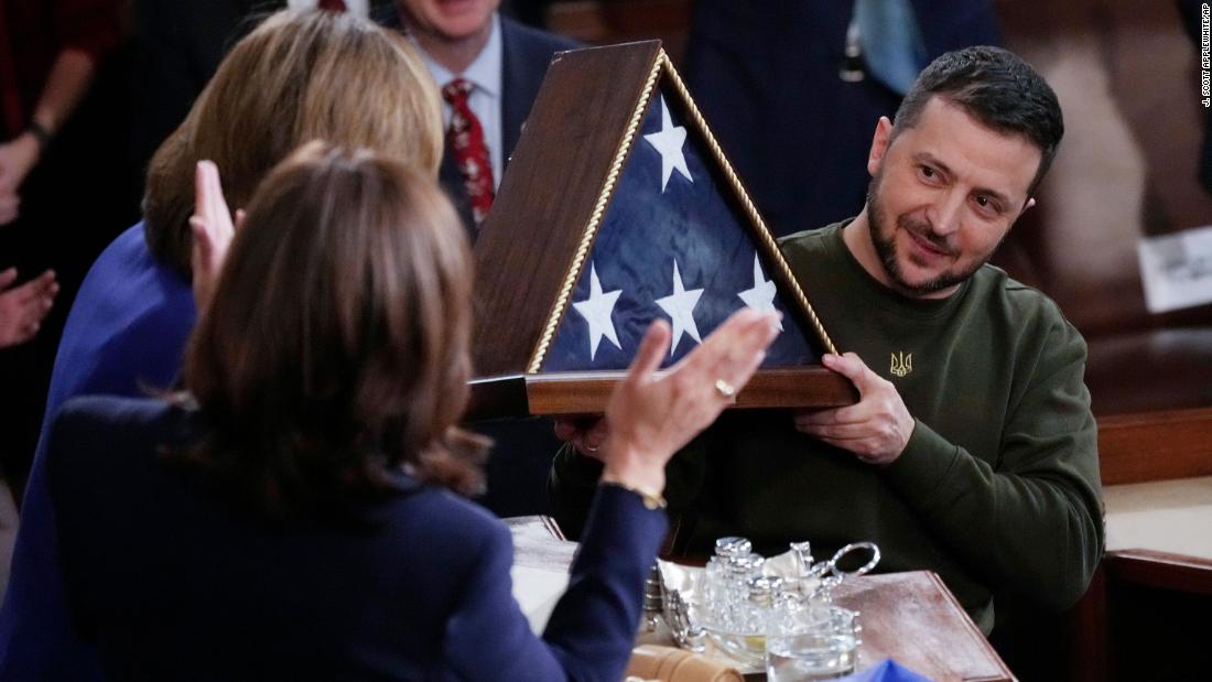 Zelensky holds an American flag that was gifted to him by Pelosi. The flag was flown over the Capitol earlier in the day.