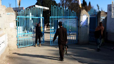 Taliban security personnel stand guard at the entrance gate of a university in Jalalabad on December 21, 2022. 