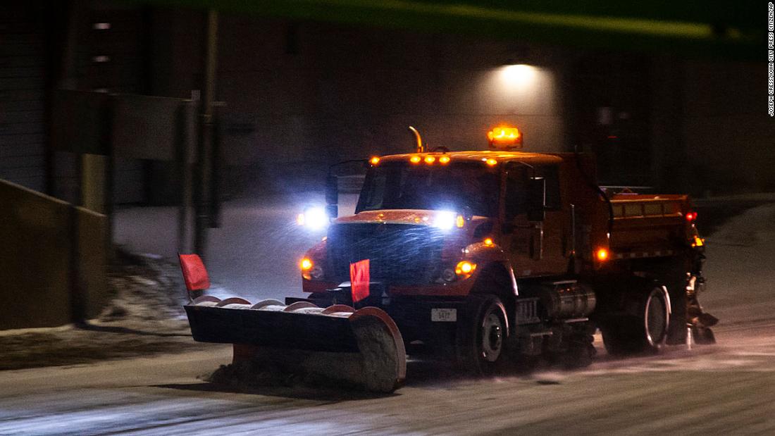 An Iowa Department of Transportation plow clears a road in Iowa City on December 21.