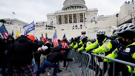 FILE - Insurrectionists loyal to President Donald Trump try to break through a police barrier, Wednesday, Jan. 6, 2021, at the Capitol in Washington. Top House and Senate leaders will present law enforcement officers who defended the U.S. Capitol on Jan. 6, 2021, with Congressional Gold Medals on Wednesday, Dec. 7, 2022, awarding them Congress&#39;s highest honor nearly two years after they fought with former President Donald Trump&#39;s supporters in a brutal and bloody attack. (AP Photo/Julio Cortez, File)