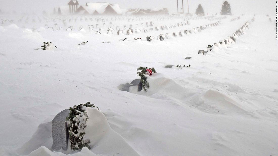 Rows of headstones at the North Dakota Veterans Cemetery are blanketed by drifting snow in Mandan on Thursday, December 22.
