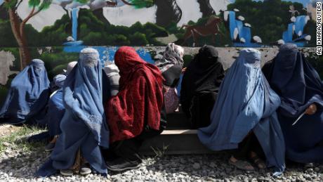 Afghan women wait to receive a food package being distributed by a Saudi Arabia humanitarian aid group at a distribution center in Kabul, Afghanistan, April 25, 2022.   