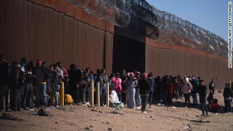 Hundreds of migrants line up to be processed by US Border Patrol under the Stanton Street Bridge after illegally entering the US, in El Paso, Texas, on December 22, 2022. 