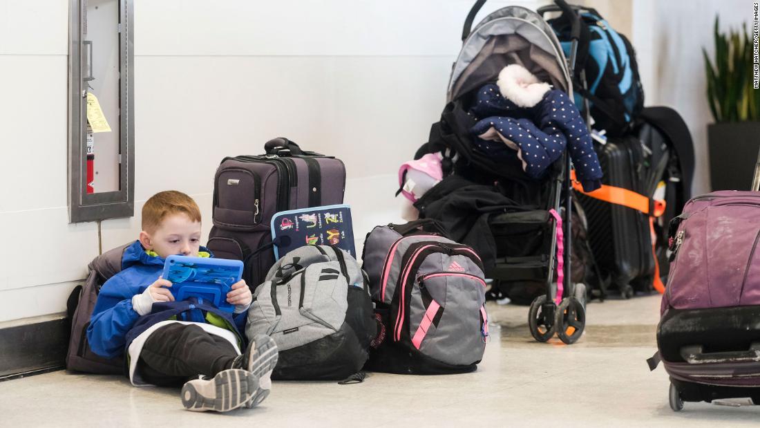 A young holiday traveler passes the time at Detroit Wayne County Metro Airport on December 24.