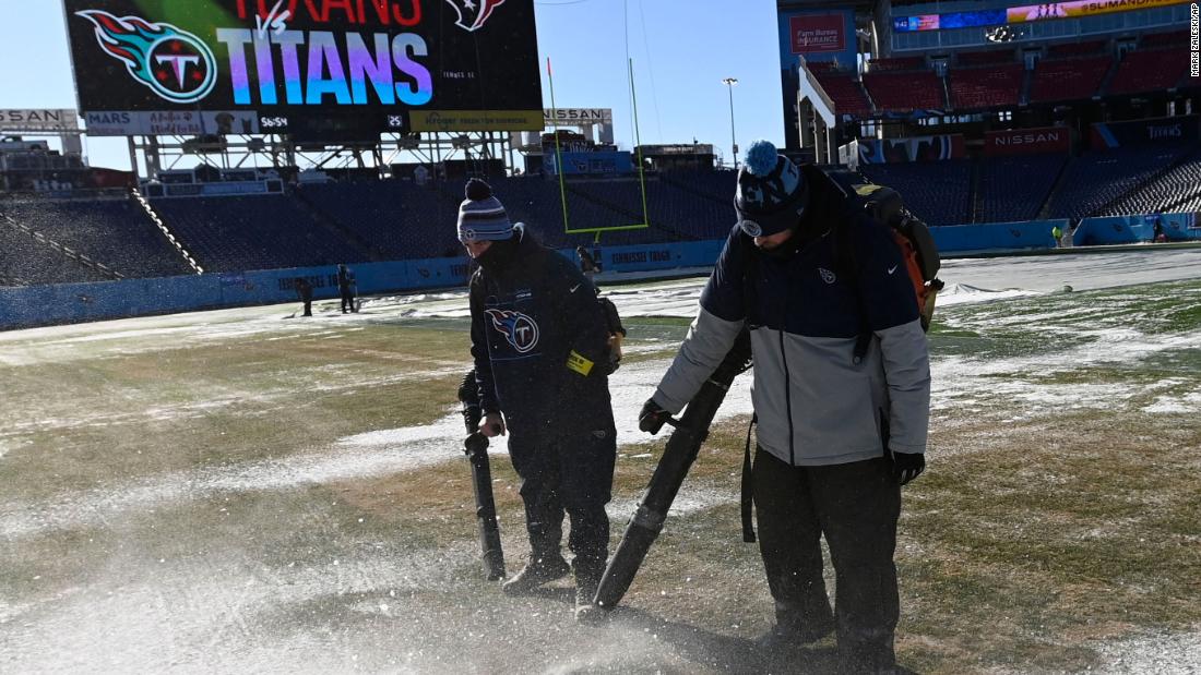 Nissan Stadium employees clear the field in Nashville before the an NFL football game on December 24.