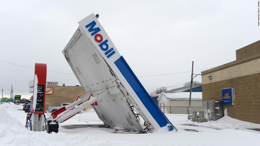 A gas station canopy lays on its side after high winds and heavy snow in Lackawanna, New York, on December 27. The historic winter storm dumped up to 4 feet of snow on the area.