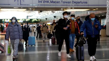 Travellers walk with their luggage at Beijing Capital International Airport in Beijing, China December 27, 2022.