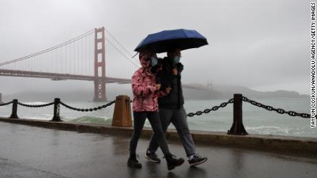 SAN FRANCISCO, CA - DECEMBER 27: A couple walks at the Fort Point near the Golden Gate Bridge as rainstorm hits San Francisco and Bay Area, California, United States on December 27, 2022. (Photo by Tayfun Coskun/Anadolu Agency via Getty Images)