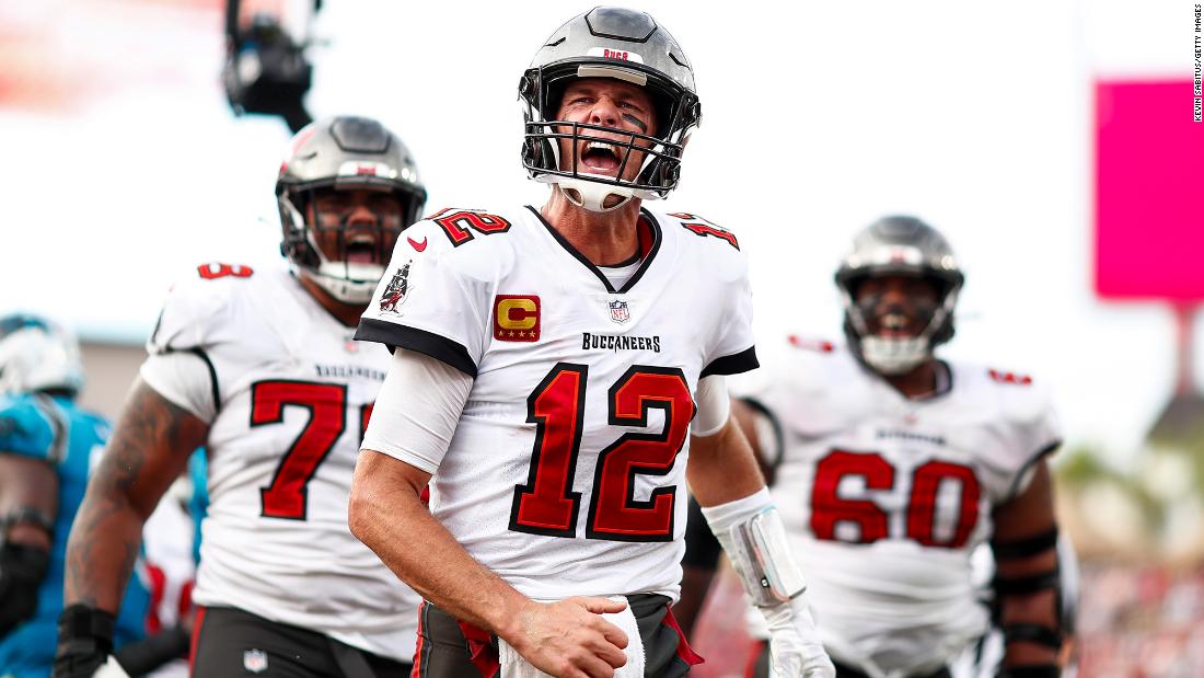 Tampa Bay quarterback Tom Brady celebrates after scoring a rushing touchdown against Carolina on Sunday, January 1. The Buccaneers clinched a postseason berth — and their second straight NFC South title — with a 30-24 win. 