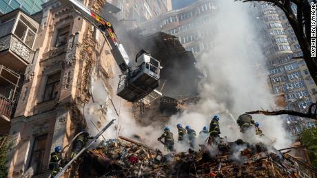 Firefighters work after a drone attack on buildings in Kyiv, Ukraine, Oct. 17, 2022.