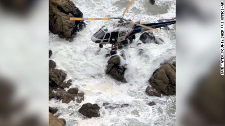 A California Highway Patrol helicopter navigated the rugged coastline to rescue two occupants of the car.