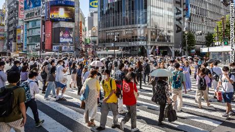 People walk through Shibuya Crossing in Tokyo on July 29, 2022.