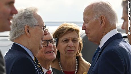 President Joe Biden greets Senate Minority Leader Mitch McConnell, left, Ohio Gov. Mike DeWine, second left, and his wife, Frances DeWine, center, on arrival at Cincinnati Northern Kentucky International Airport in Hebron, Kentucky, on January 4, 2023. (Photo by Jim Watson/AFP/Getty Images)