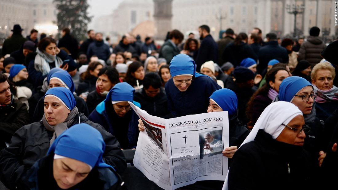 Nuns read L&#39;Osservatore Romano at St. Peter&#39;s Square on the day of the funeral of former Pope Benedict at the Vatican.