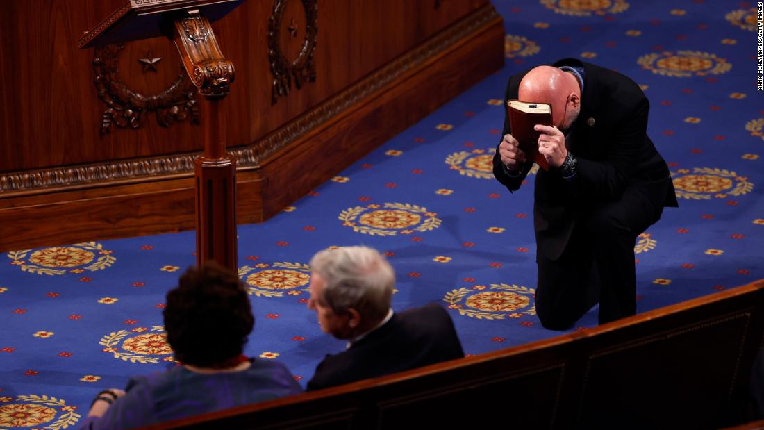 US Rep. Clay Higgins, a Republican from Louisiana, prays in the House chamber on Thursday.
