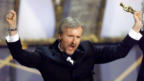 James Cameron holds up the Oscar he won for best director for the movie &quot;Titanic&quot; March 23, 1998.