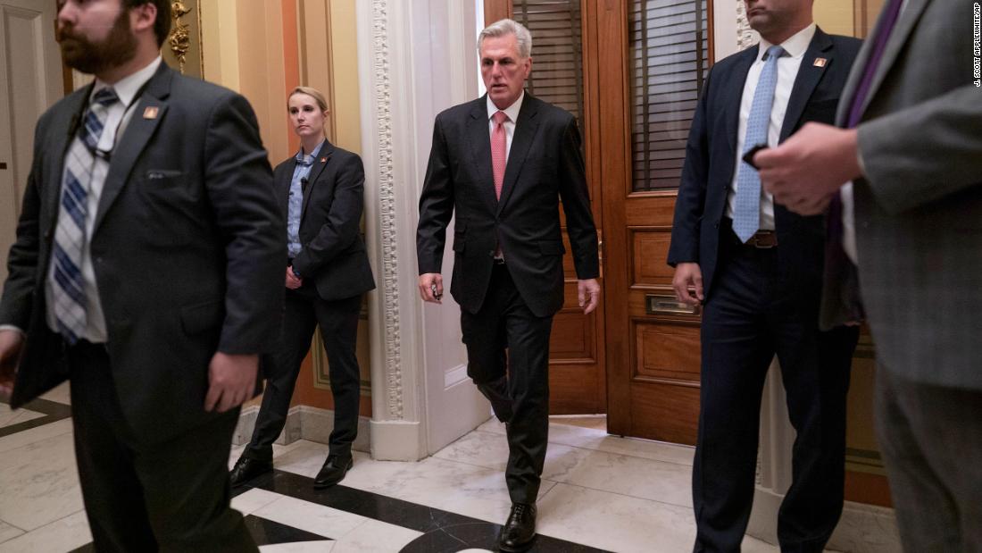 McCarthy leaves a private meeting room off the House floor as he negotiates with lawmakers in his own party on Thursday.