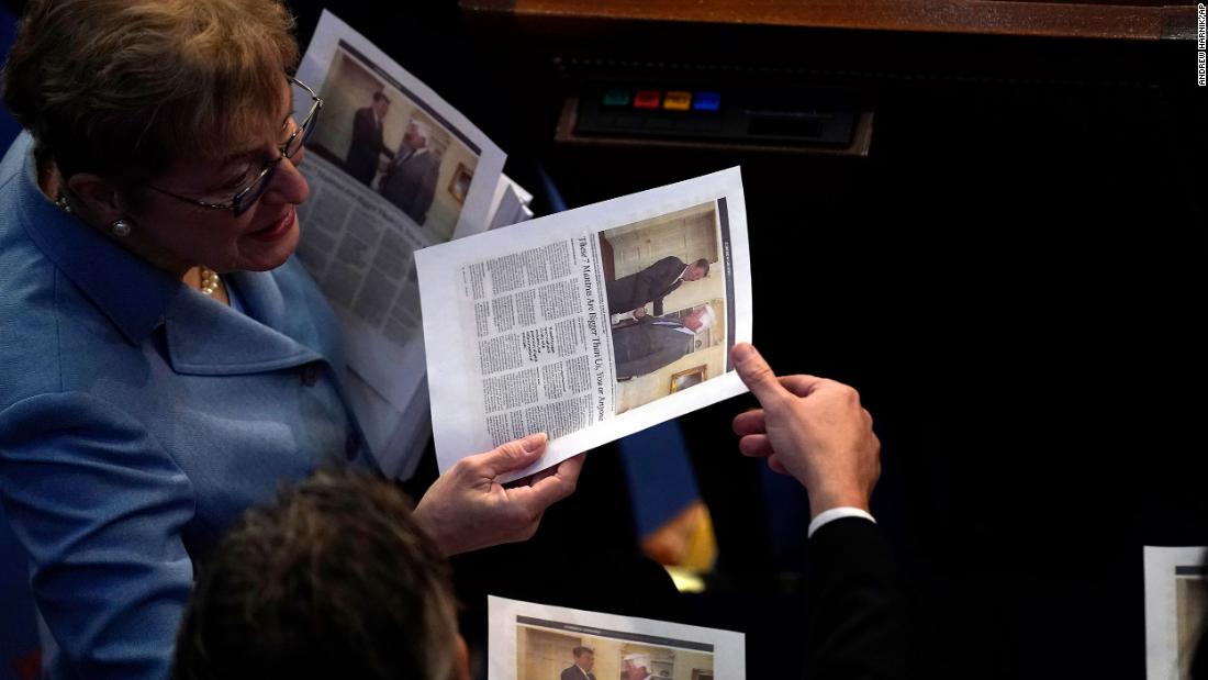 House members read a printed news article inside the chamber on Friday.