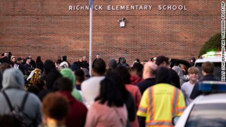 Students and police gather outside of Richneck Elementary School after a shooting, Friday, January 6, 2023, in Newport News, Virginia.